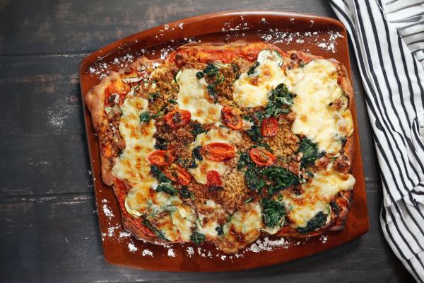 Vegan vegetable and mince pizza with vegan cheese sauce
