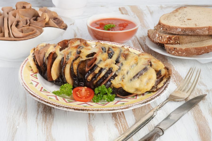 Vegan stuffed aubergine au gratin